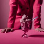 Bowls of ice cream on a pink table.