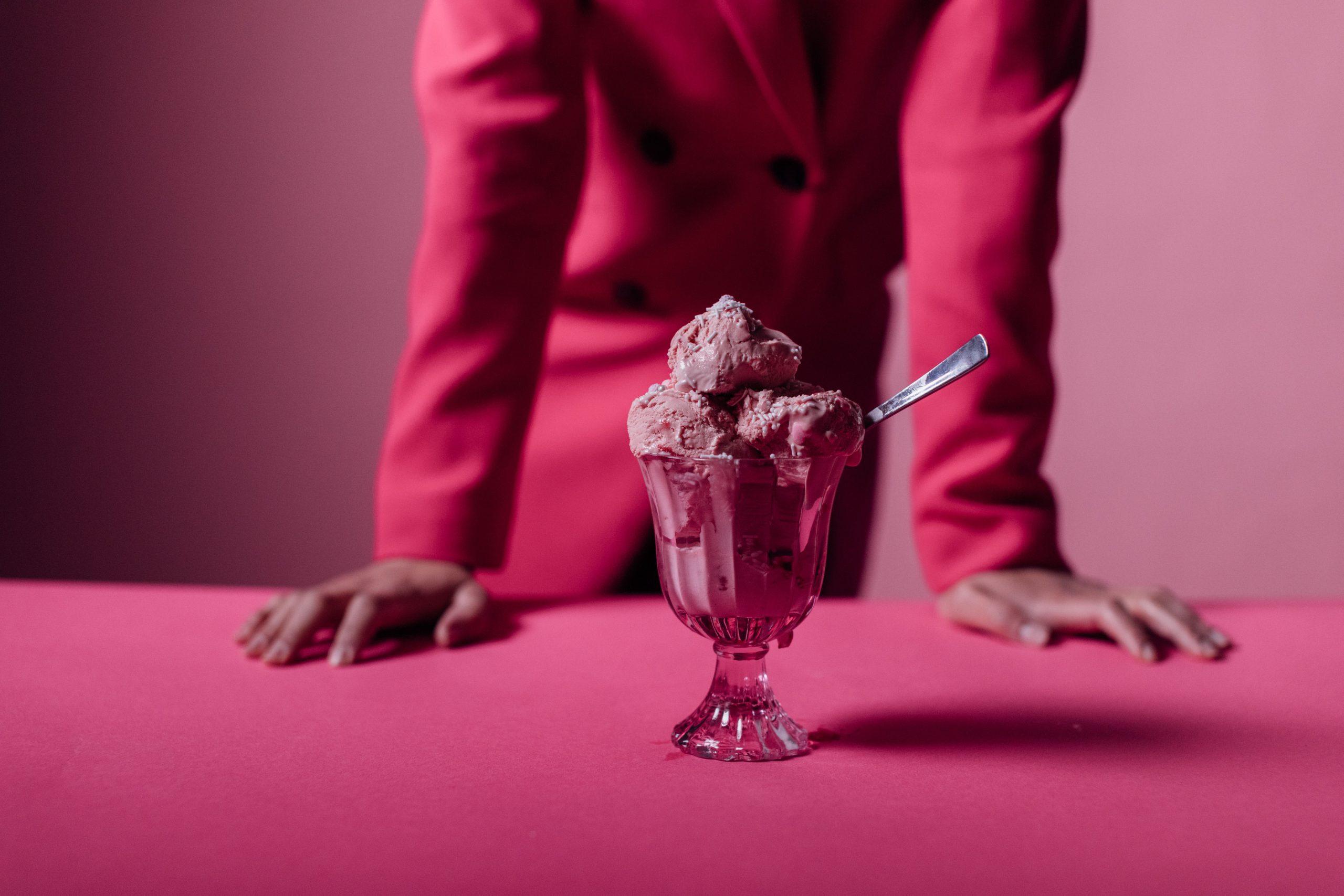 Bowls of ice cream on a pink table.